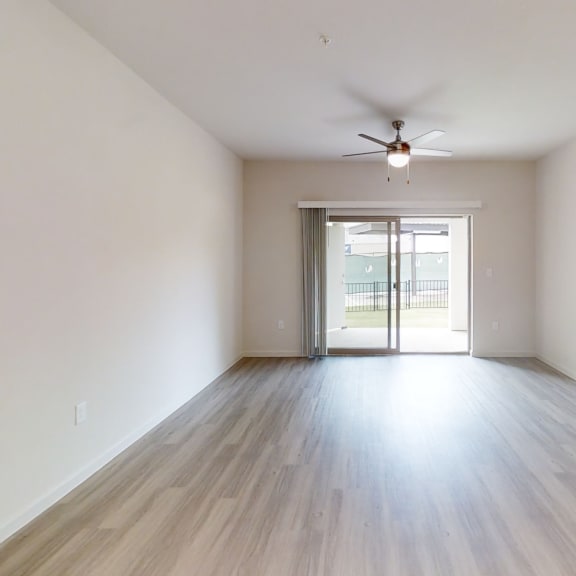 Thumbnail 5 of 8 a bedroom with hardwood floors and a ceiling fan
