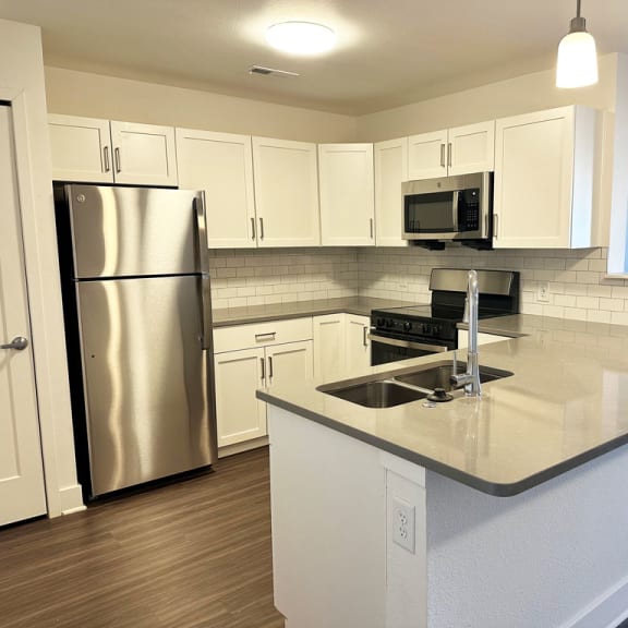 Thumbnail 8 of 14 a kitchen with white cabinets and stainless steel appliances  at Signature Pointe Apartment Homes, Athens, 35611