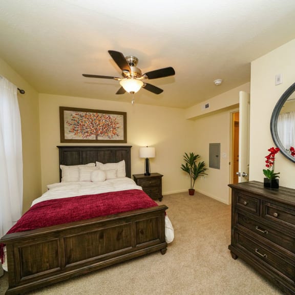 Thumbnail 8 of 9 a bedroom with a bed and a ceiling fan  at Andover Pointe Apartment Homes, La Vista, NE, 68138