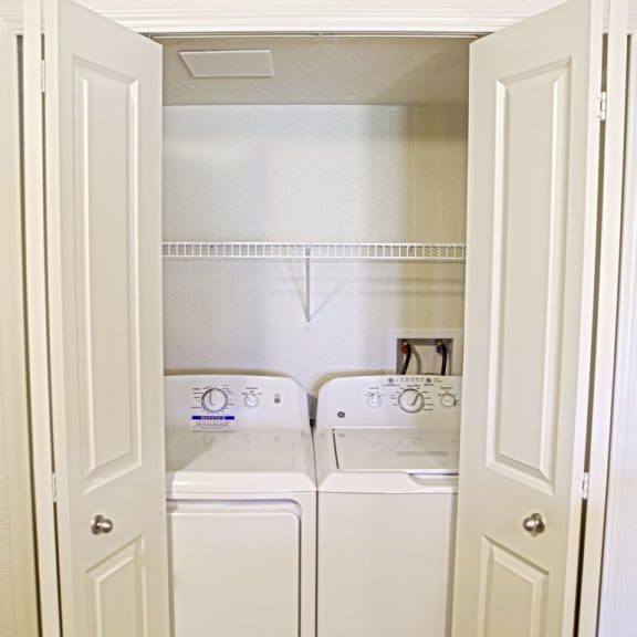 Thumbnail 6 of 9 a washer and dryer in a laundry room with white doors at Andover Pointe Apartment Homes in LaVista, NE