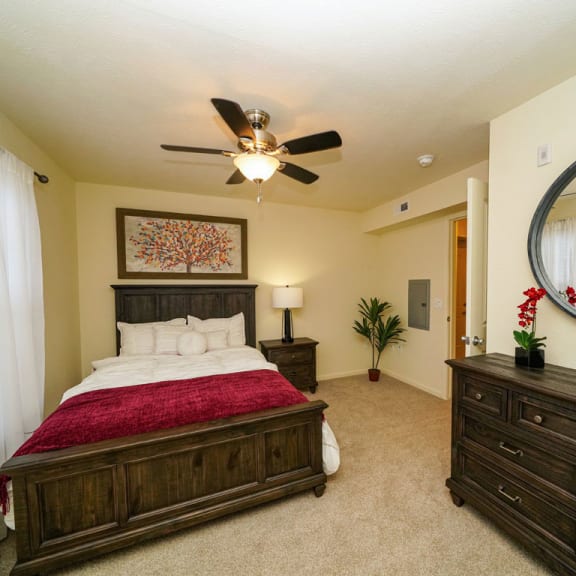 Thumbnail 4 of 9 a bedroom with a bed and a ceiling fan at Andover Pointe Apartment Homes in LaVista, NE