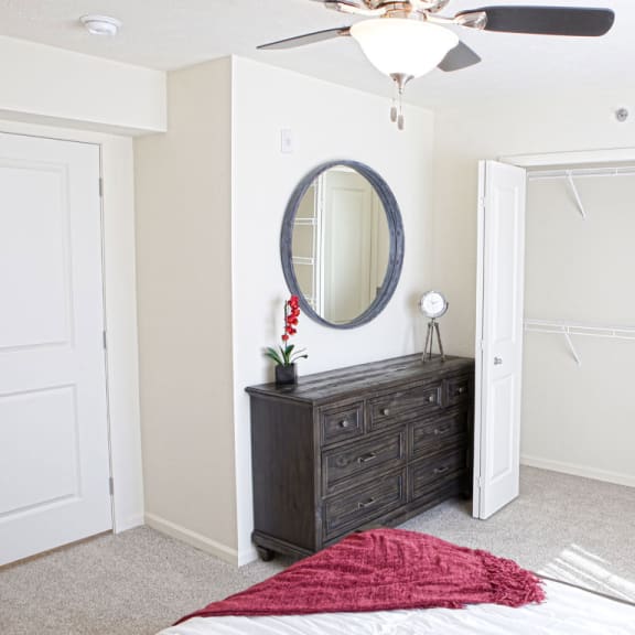 Thumbnail 5 of 9 a bedroom with a closet and a bed and a mirror  at Andover Pointe Apartment Homes, La Vista, 68138