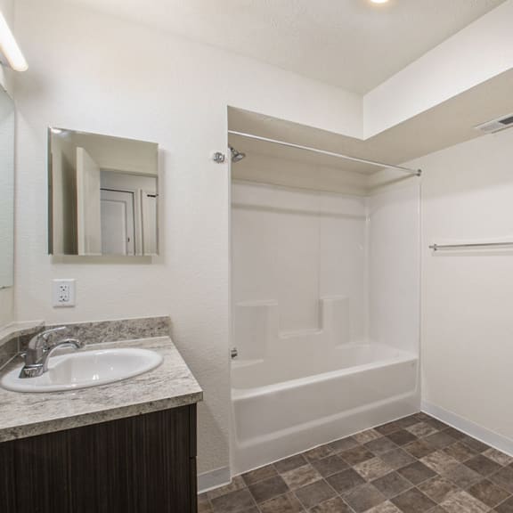 Thumbnail 7 of 10 primary bathroom with a sink toilet and a shower  at Andover Pointe Apartment Homes, Nebraska
