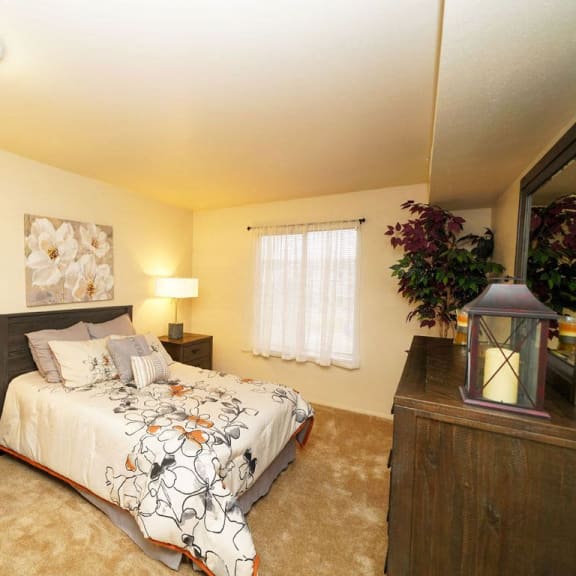 Thumbnail 7 of 8 a bedroom with a bed and a window  at Apple Ridge Apartments, Michigan, 49534
