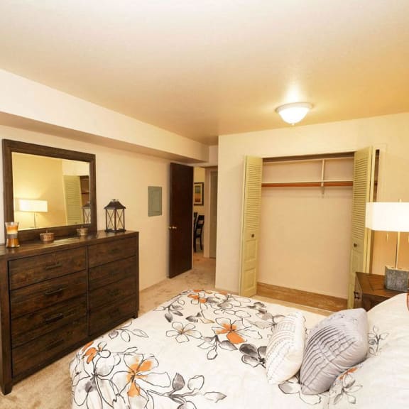 Thumbnail 8 of 8 a bedroom with a bed and a dresser  at Apple Ridge Apartments, Walker, MI