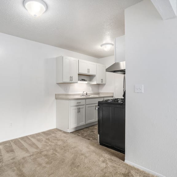 Thumbnail 6 of 14 kitchen with white cabinets and dining area at Apple Ridge Apartments, Michigan, 49534