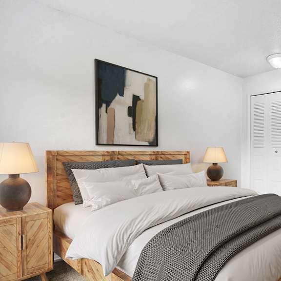 Thumbnail 10 of 11 A bedroom with a large bed and closet at Apple Ridge Apartments, Walker, MI