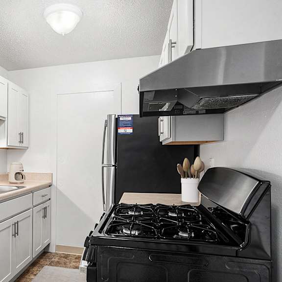 Thumbnail 6 of 11 An upgraded kitchen with white cabinets and stainless steel appliances at Apple Ridge Apartments, Walker, MI