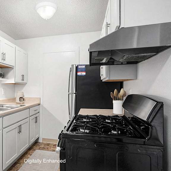 Thumbnail 6 of 8 A kitchen with white cabinets and stainless steel appliances  at Apple Ridge Apartments, Walker, MI