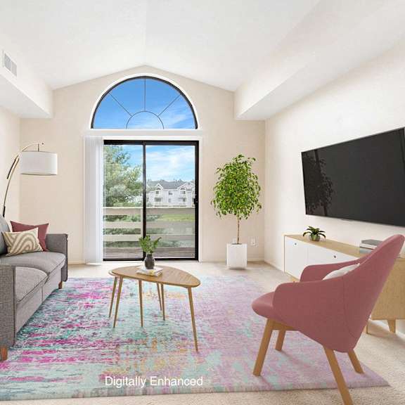 Thumbnail 3 of 13 A living room with a cathedral ceiling and a grey couch at Arbor Lakes Apartments in Elkhart, IN