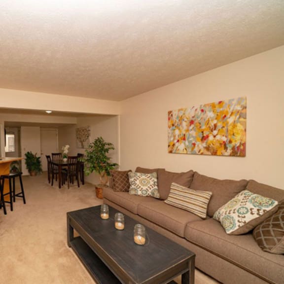 Thumbnail 7 of 13 a living room with a couch and a table  at Arbor Lakes Apartments, Elkhart, 46516