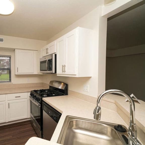Thumbnail 5 of 8 a kitchen with a sink and a stove and a refrigerator  at Arbor Lakes Apartments, Elkhart, IN, 46516