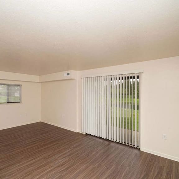 Thumbnail 3 of 8 an empty living room with a sliding glass door  at Arbor Lakes Apartments, Elkhart, IN