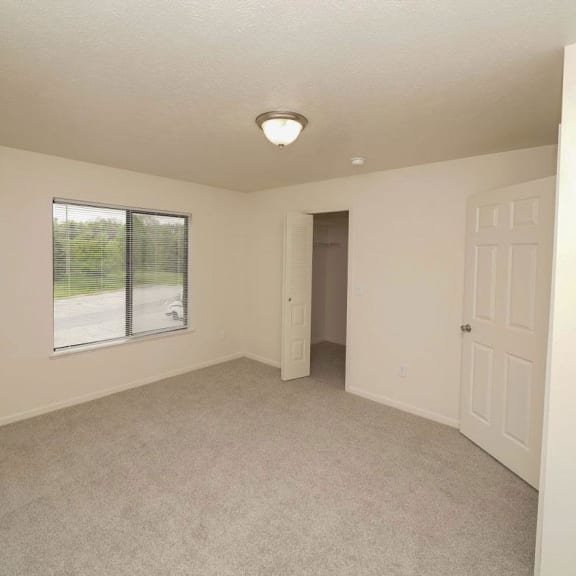 Thumbnail 7 of 8 a bedroom with a closet and a white door  at Arbor Lakes Apartments, Indiana, 46516