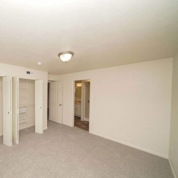 Thumbnail 11 of 13 an empty living room with a closet  at Arbor Lakes Apartments, Indiana, 46516