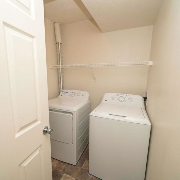 Thumbnail 7 of 13 a washer and dryer in a room with a door  at Arbor Lakes Apartments, Elkhart, IN, 46516