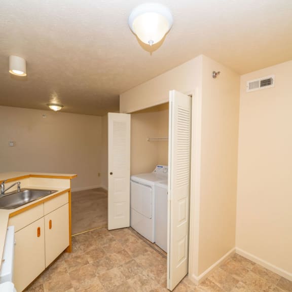 Thumbnail 6 of 9 a kitchen and laundry room with a washer and dryer closet at Autumn Lakes Apartments and Townhomes, Indiana, 46544