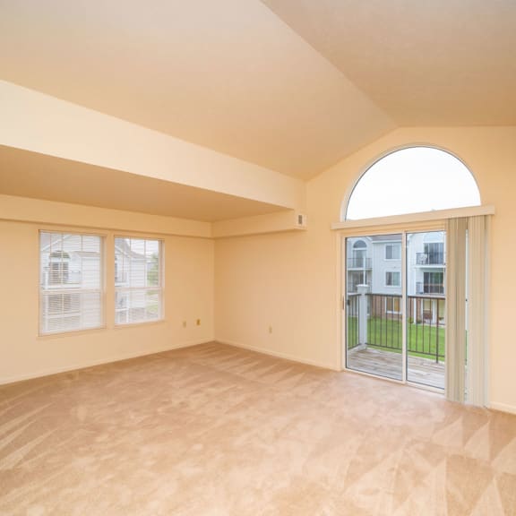 Thumbnail 3 of 9 an empty living room with a door to a patio at Autumn Lakes Apartments and Townhomes, Mishawaka, 46544