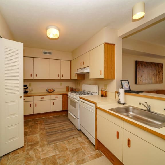 Thumbnail 5 of 7 a kitchen with white cabinets and a sink at Autumn Lakes Apartments and Townhomes, Mishawaka, 46544
