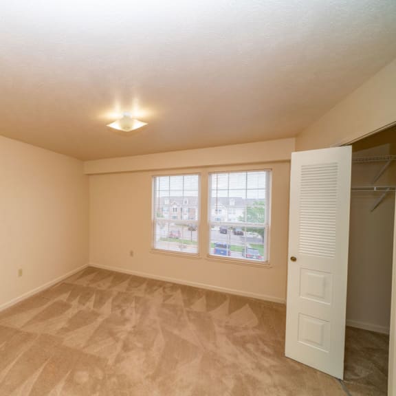 Thumbnail 8 of 9 an empty living room with a closet and a window at Autumn Lakes Apartments and Townhomes, Mishawaka, IN