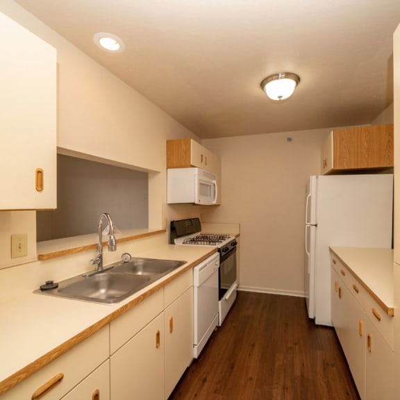 Thumbnail 6 of 14 a kitchen with a sink and a stove and a refrigerator at Autumn Lakes Apartments and Townhomes, Mishawaka, IN