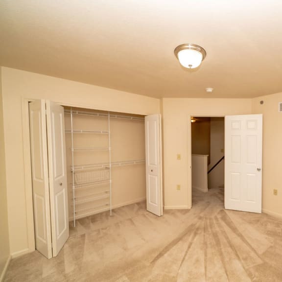 Thumbnail 9 of 11 an empty bedroom with a closet and a door to a bathroom at Autumn Lakes Apartments and Townhomes, Mishawaka, 46544