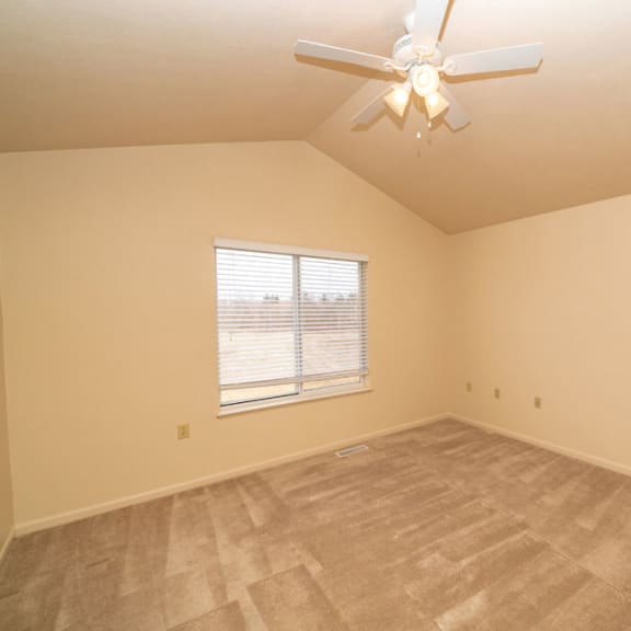 Thumbnail 10 of 11 an empty bedroom with a ceiling fan and a window at Autumn Lakes Apartments and Townhomes, Mishawaka