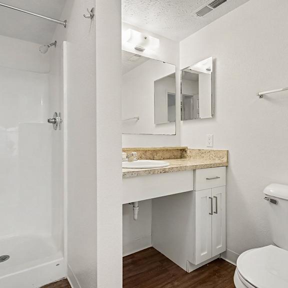Thumbnail 22 of 22 A white bathroom with a tub, toilet, and sink.