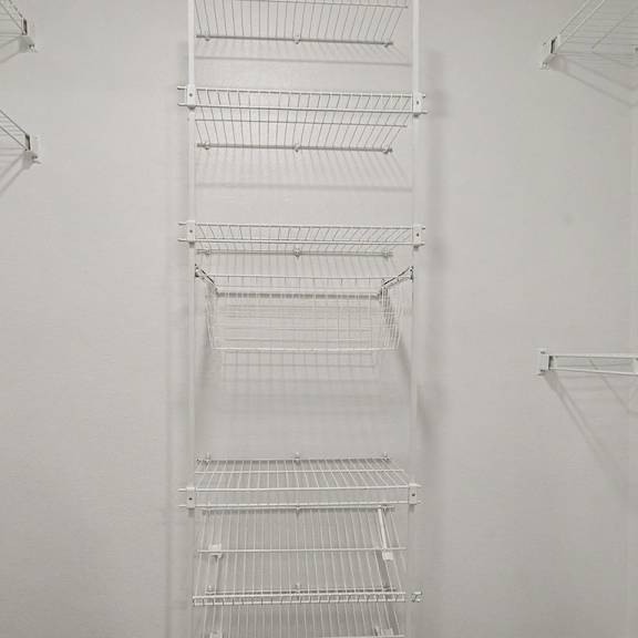 Thumbnail 21 of 22 Empty white shelves in a refrigerator.