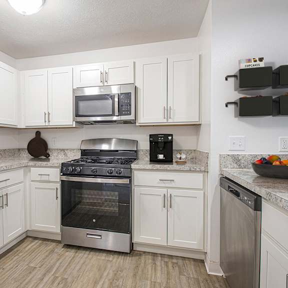 Thumbnail 6 of 11 A kitchen with white cabinets and a stainless steel appliances at Autumn Lakes Apartments and Townhomes in Mishawaka, IN