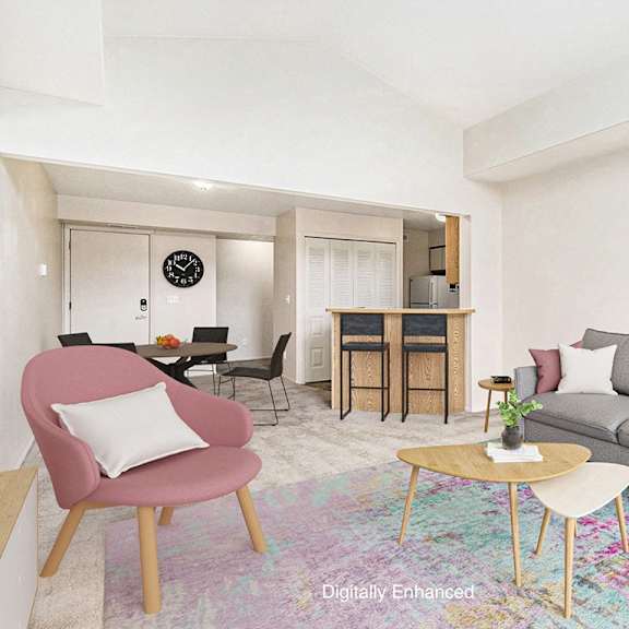Thumbnail 4 of 7 A living room with a grey couch and a high ceiling at Autumn Lakes Apartments and Townhomes in Mishawaka, IN