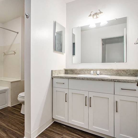 Thumbnail 11 of 16 A white bathroom with a tub, toilet, and sink at Autumn Lakes Apartments and Townhomes, Mishawaka, 46544