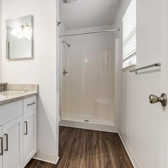 Thumbnail 10 of 16 A bathroom with a sink, mirror, and window at Autumn Lakes Apartments and Townhomes, Mishawaka, 465444