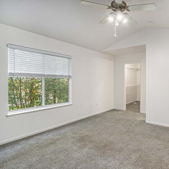 Thumbnail 9 of 16 A bedroom with a ceiling fan and carpeted floor at Autumn Lakes Apartments and Townhomes, Mishawaka, 46544