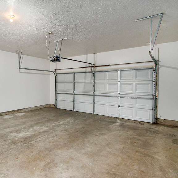 Thumbnail 16 of 16 A 2+ car garage with a white wall and a white door at Autumn Lakes Apartments and Townhomes, Mishawaka, 46544