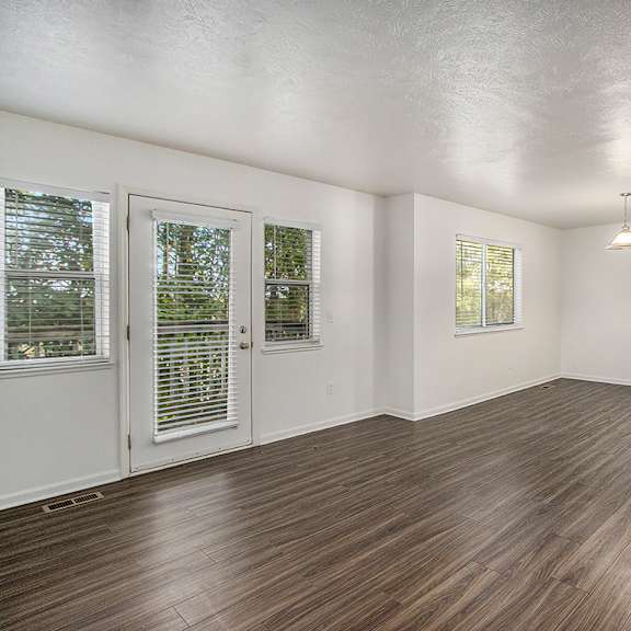 Thumbnail 3 of 16 A living and dining room with vinyl plank flooring at Autumn Lakes Apartments and Townhomes, Mishawaka, 46544