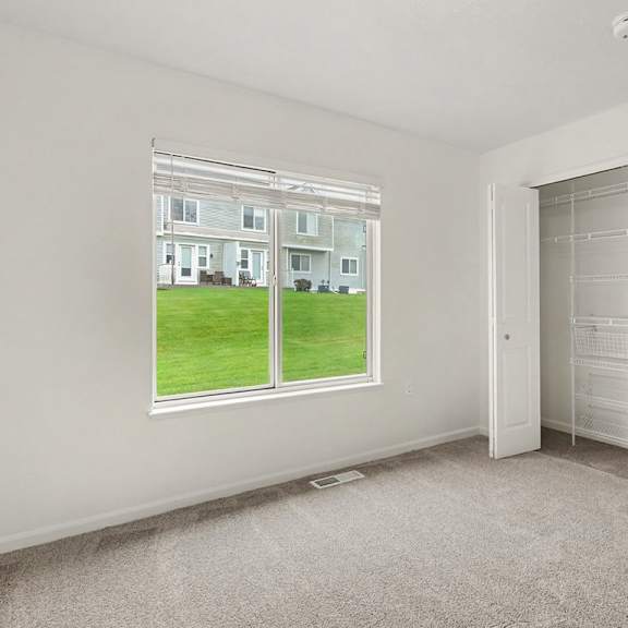 Thumbnail 11 of 18 A room with a large window and a white door.
