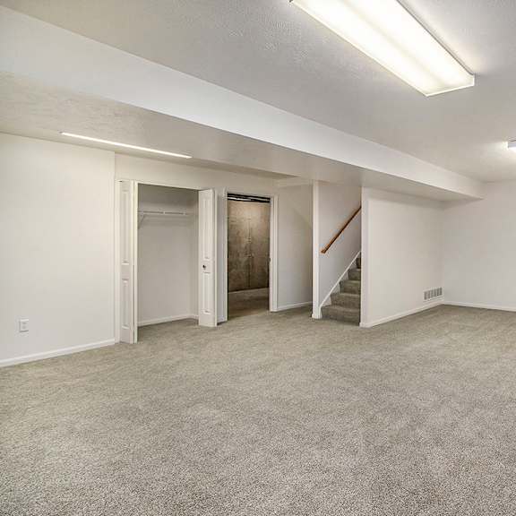 Thumbnail 12 of 14 A spacious recreation room with a staircase and a window at Autumn Lakes Apartments and Townhomes, Mishawaka, 46544