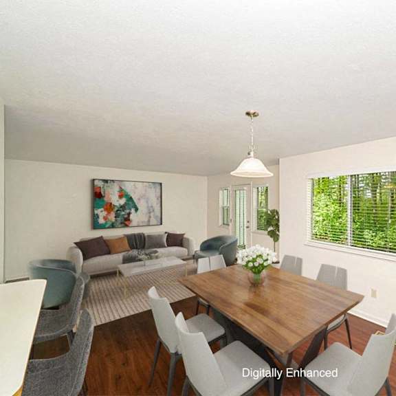 Thumbnail 5 of 15 A dining room with a wooden table and chairs at Autumn Lakes Apartments and Townhomes in Mishawaka, Indiana