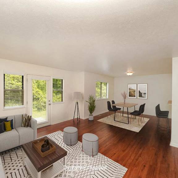 Thumbnail 3 of 15 A living room with a grey couch, a coffee table, and a rug at Autumn Lakes Apartments and Townhomes, Indiana
