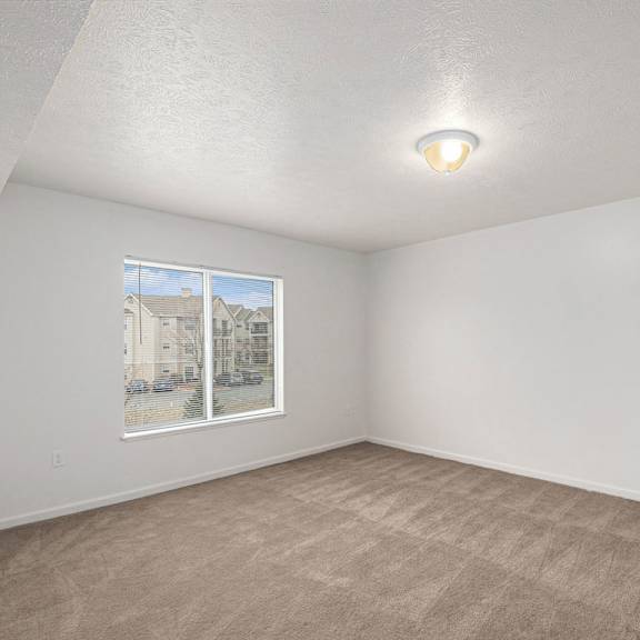 Thumbnail 12 of 14 A bedroom with a carpeted floor and a window at Black Sand Apartment Homes, Lincoln, Nebraska