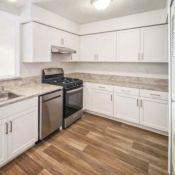Thumbnail 7 of 10 an upgraded kitchen with white cabinets and stainless steel appliances at Black Sand Apartment Homes in Lincoln, NE