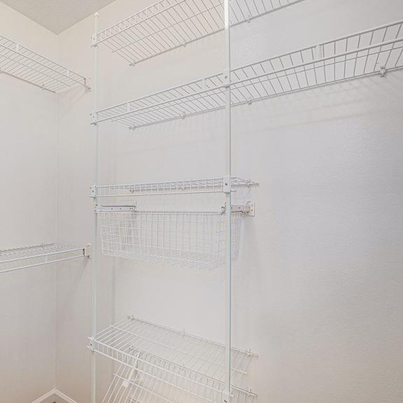 Thumbnail 11 of 14 A walk in closet with wardrobe organizers at Black Sand Apartment Homes, Lincoln, Nebraska