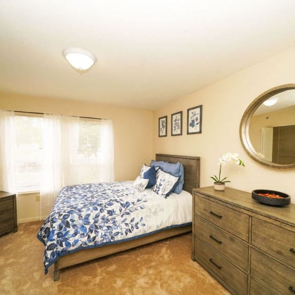 Thumbnail 12 of 14 a bedroom with a bed and a mirror at Brentwood Park Apartments, La Vista, Nebraska