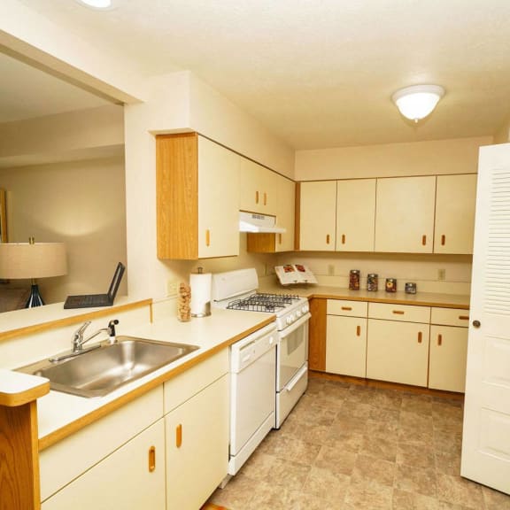 Thumbnail 8 of 14 a kitchen with white cabinets and a sink at Brentwood Park Apartments, La Vista, NE, 68128