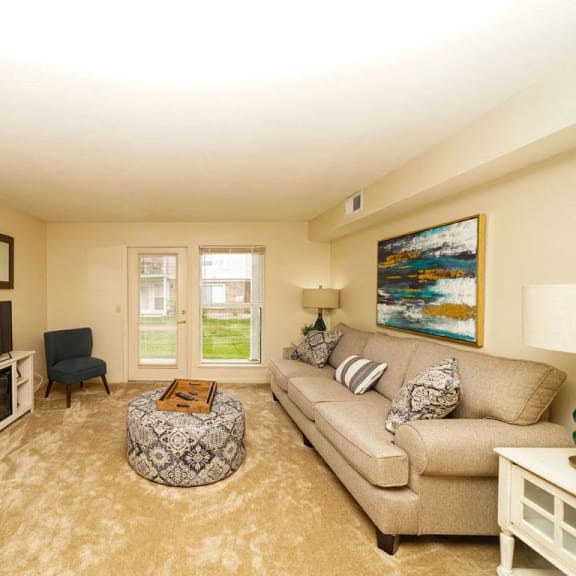 Thumbnail 5 of 14 a living room with a couch and a television at Brentwood Park Apartments, La Vista, NE