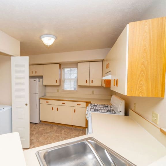 Thumbnail 8 of 12 a kitchen with a washer and dryer and a sink at Brentwood Park Apartments, La Vista, NE