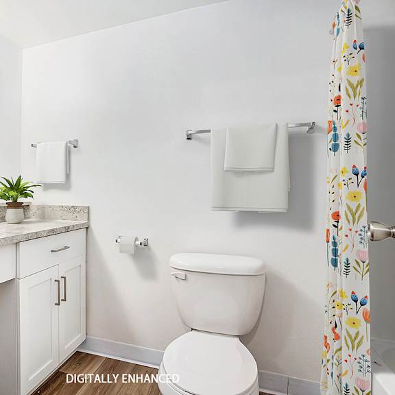Thumbnail 10 of 14 An upgraded bathroom with a toilet next to a white sink at Brentwood Park Apartments, La Vista, 68128