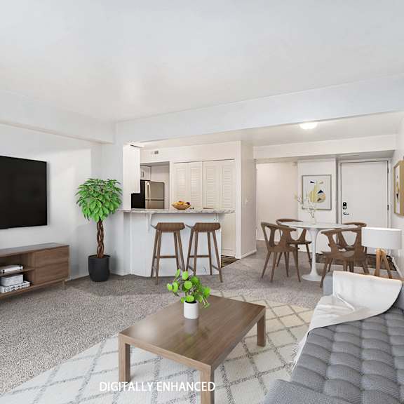 Thumbnail 3 of 14 A modern living room with a grey sofa, a coffee table, and plush carpeting at Brentwood Park Apartments, La Vista, 68128