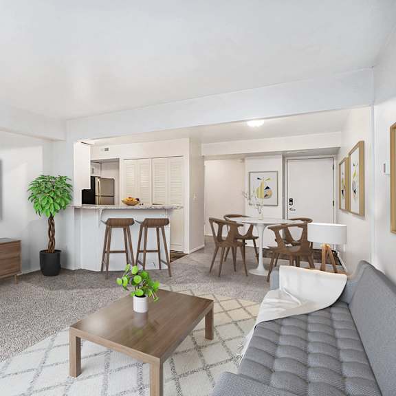 Thumbnail 8 of 19 A living room with a grey sofa, wooden coffee table, and a television at Brentwood Park Apartments in LaVista, NE